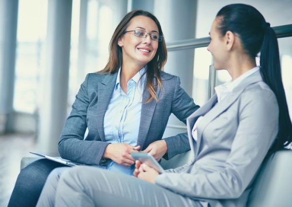Image of two confident businesswomen discussing new ideas
